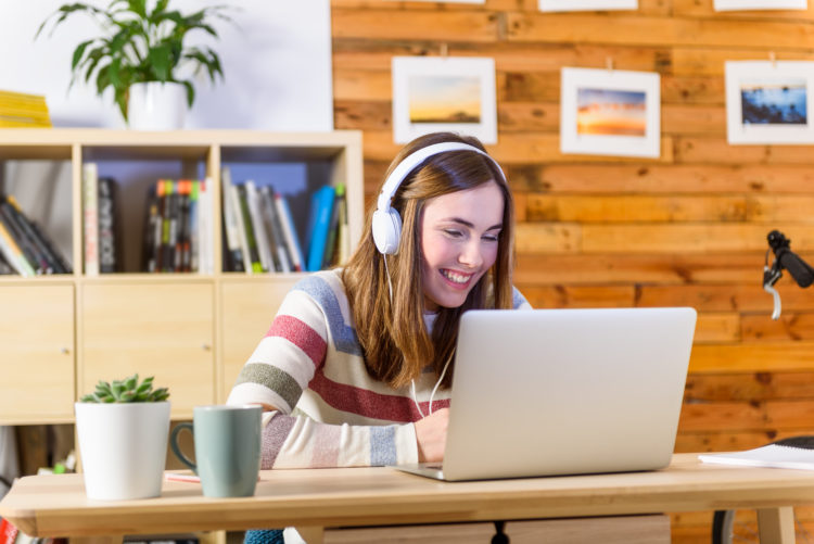 Woman learning with video tutorial and podcast from laptop