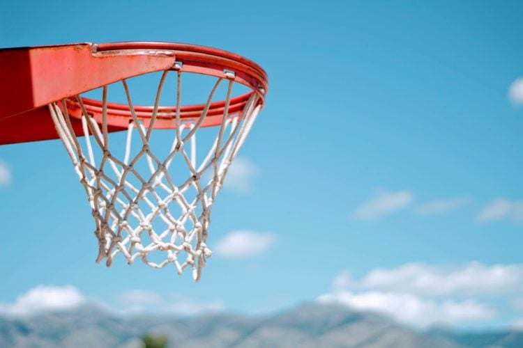 red basketball hoop with white net during daytime