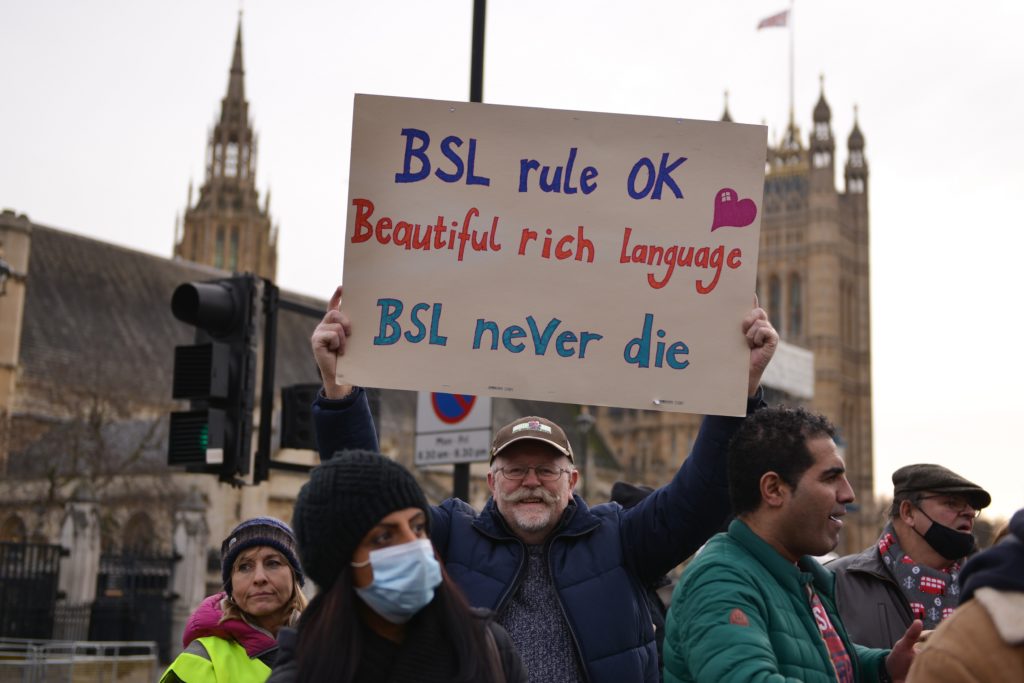 A protester seen holding a placard expressing her opinion