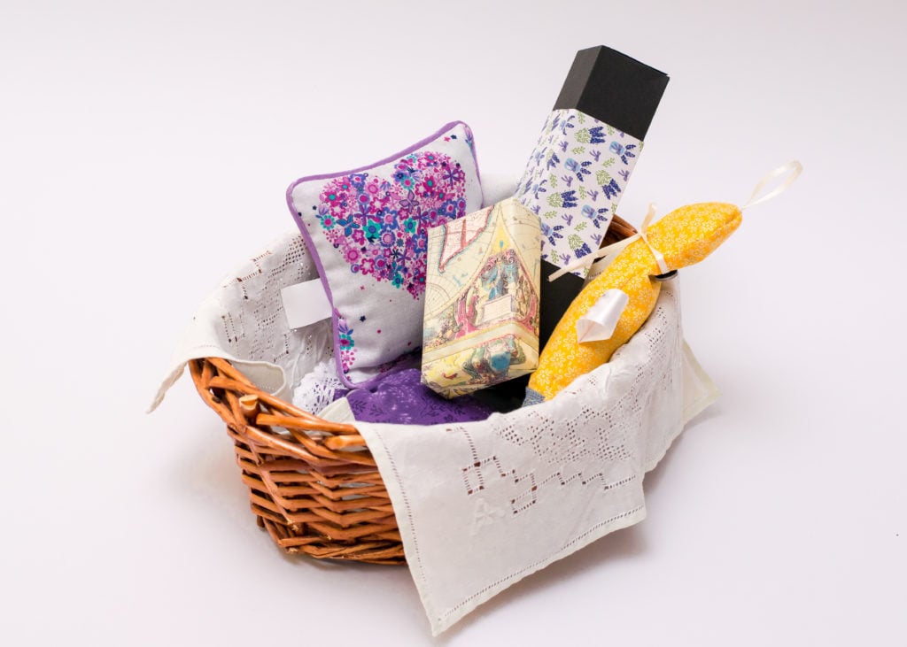 Gifts In Wicker Basket Over White Background