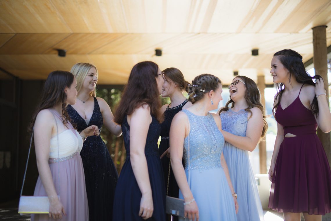 woman in white wedding gown standing beside woman in black sleeveless dress