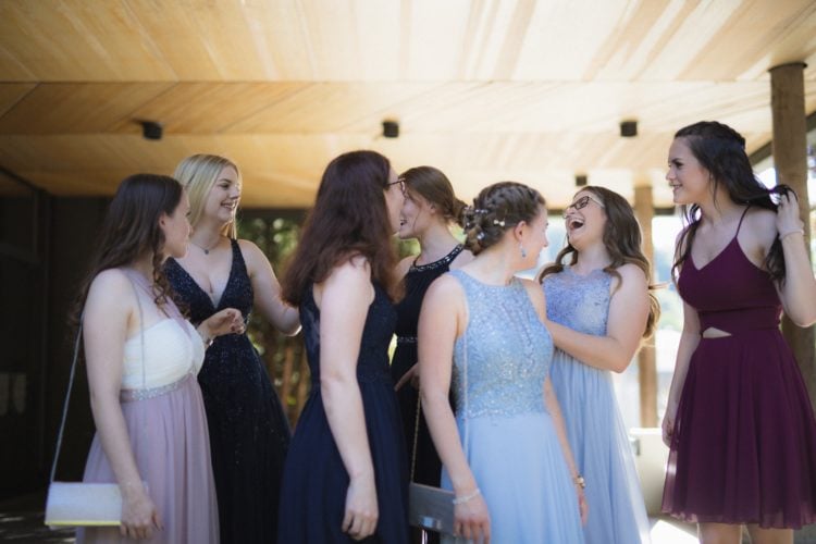 woman in white wedding gown standing beside woman in black sleeveless dress