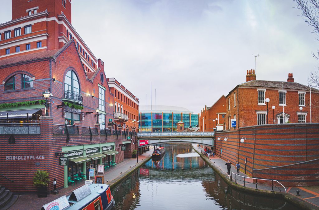 red and brown concrete building beside river during daytime