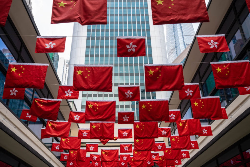 Rows of Chinese and Hong Kong flags in a market. Rows of