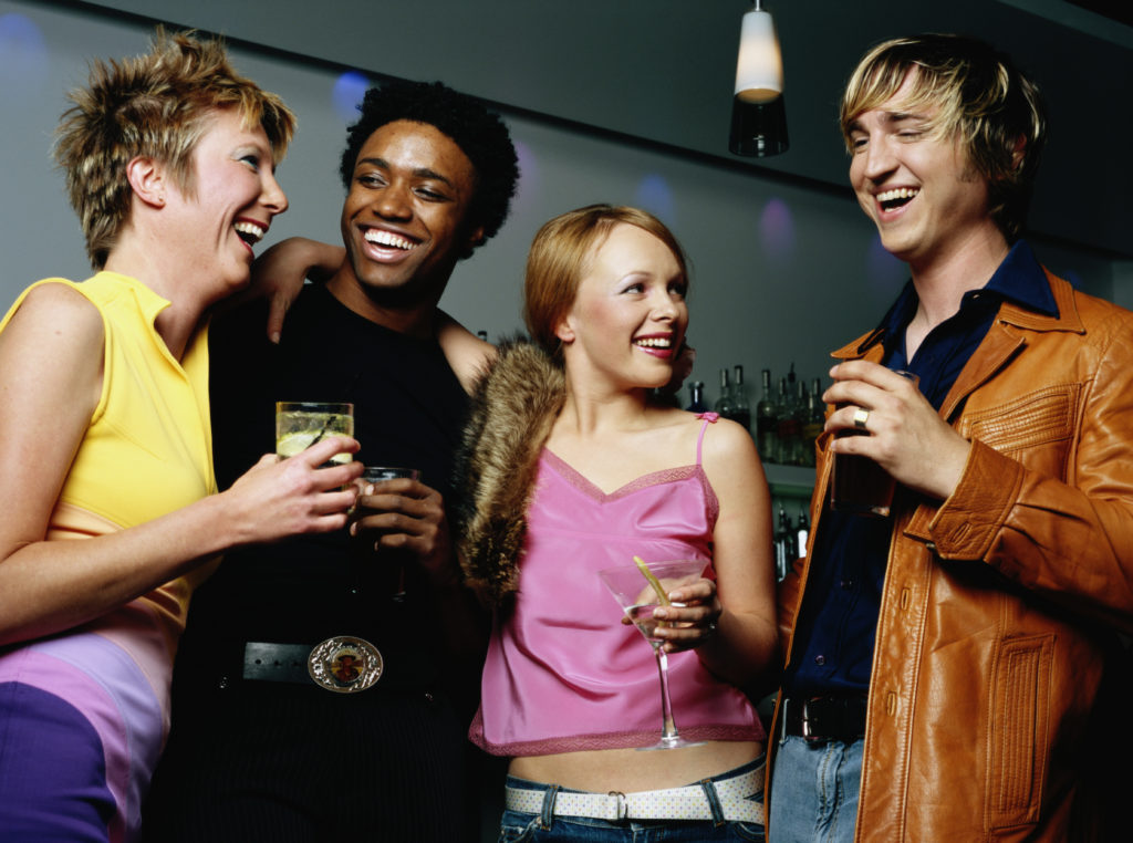 Four people socializing in lounge