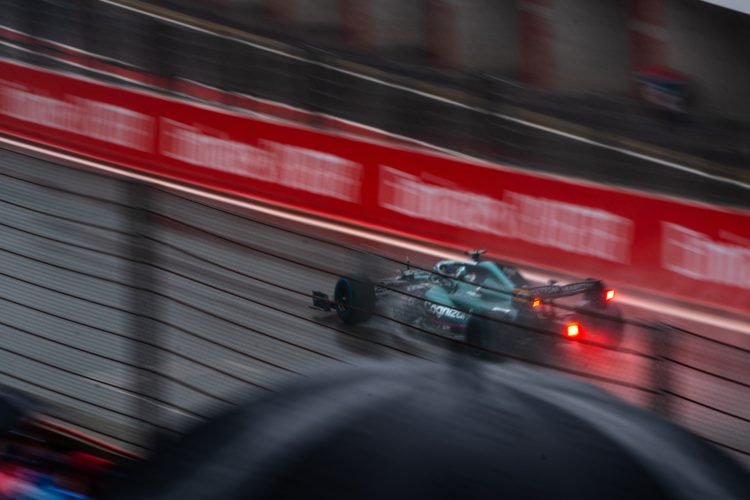green and red race car on track