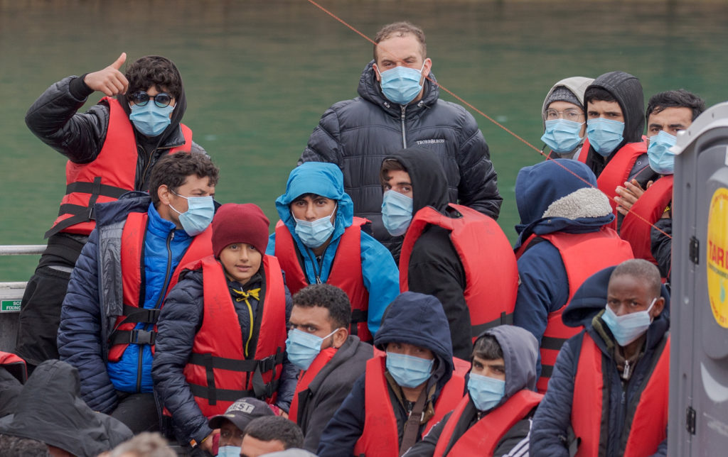 Channel crossings: Migrants brought ashore in Dover