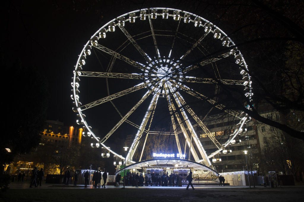A ferris wheel is illuminated at night in Elizabeth Square
