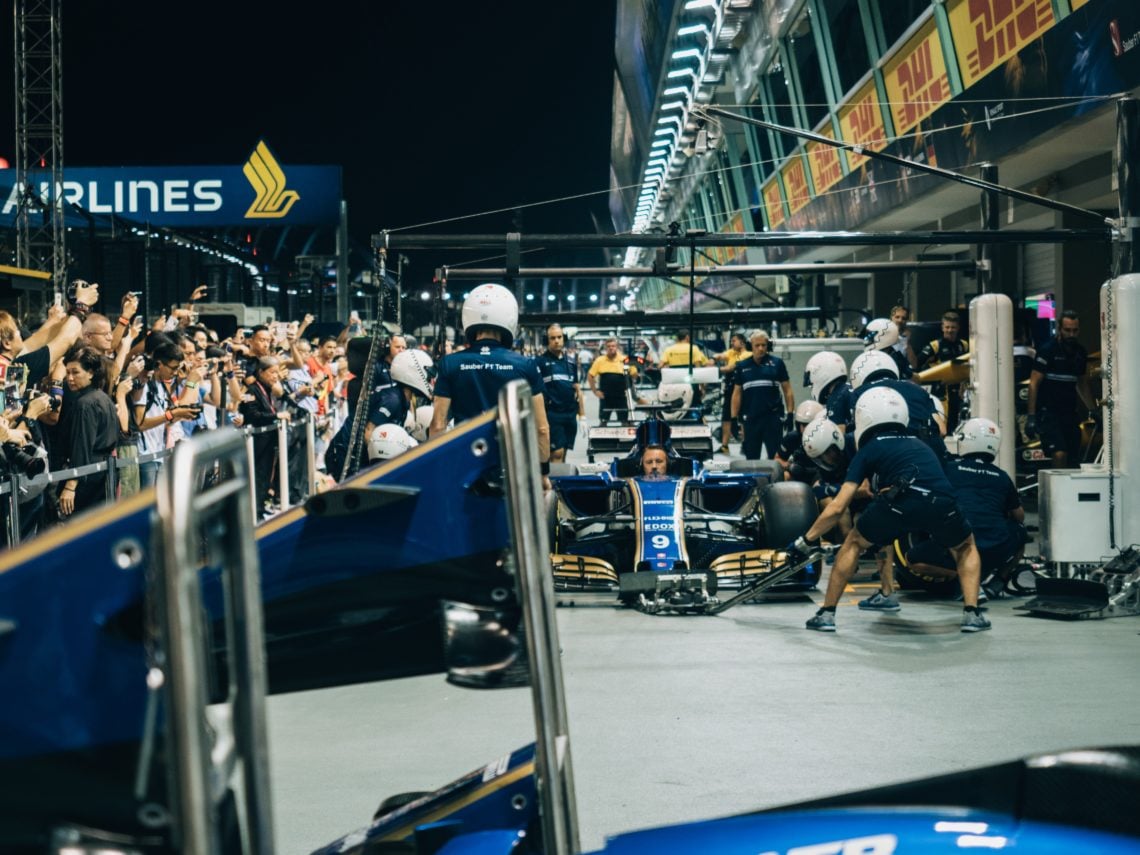 man driving F1 car during nighttime