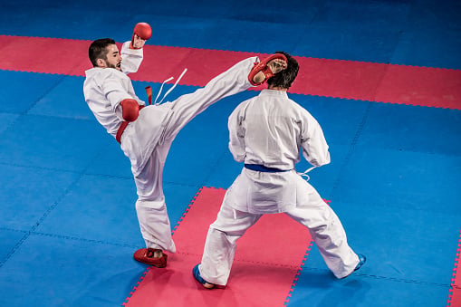 Male karate players fighting during the competition.