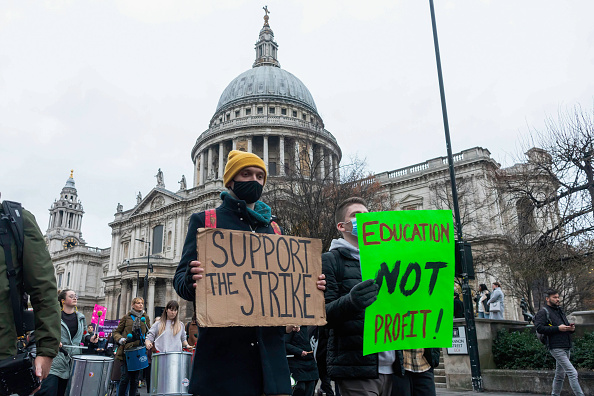 Protestors seen holding placards that say 'support the