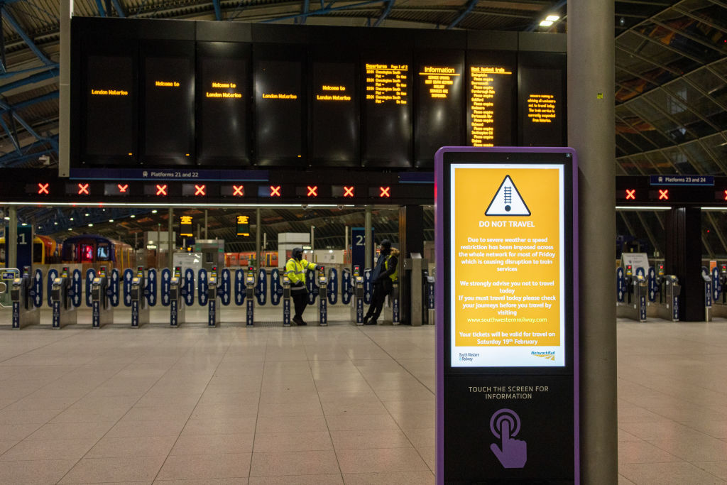 A sign of train cancellation due to storm Eunice displays at