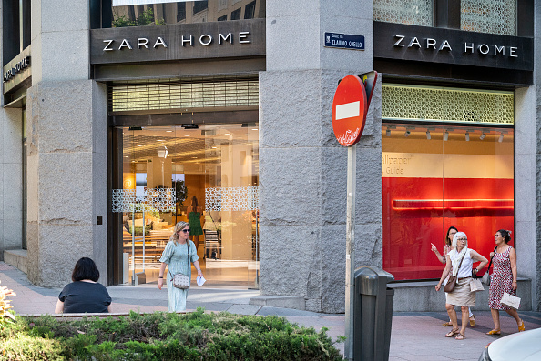 Pedestrians walk past the Spanish Inditex group dedicated to