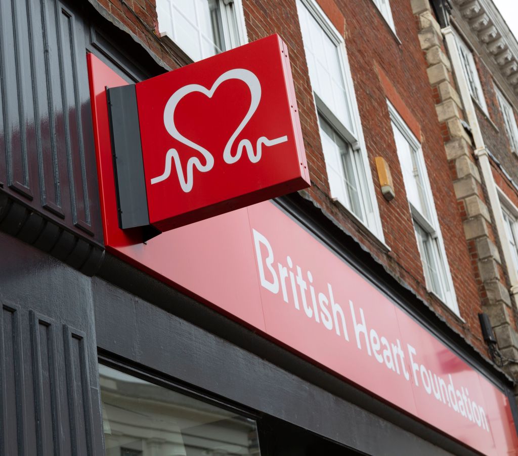 Wall mounted sign outside British Heart Foundation charity shop, Devizes, Wiltshire, England, UK