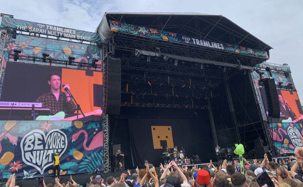 The Wombats performing on stage in front of a large crowd