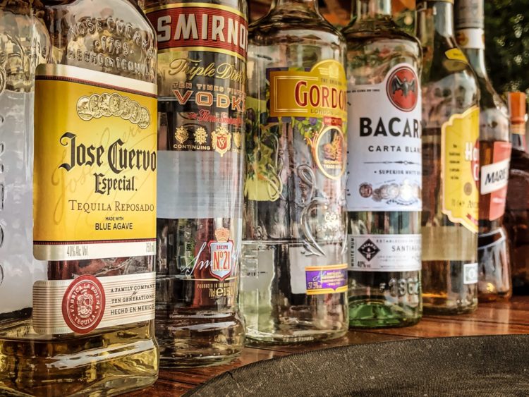 clear glass bottles on gray concrete floor