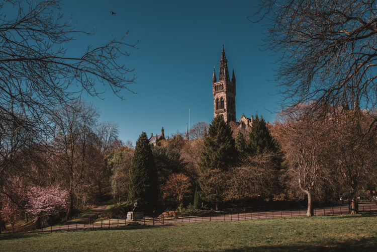 Founded in 1451, the Gothic revival style building of Glasgow University rises over the treetops of Kelvingrove Park. Glasgow, Scotland.