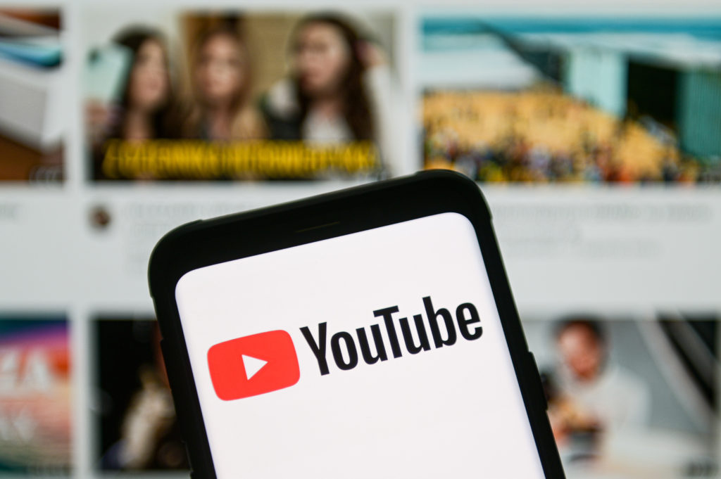 In this photo illustration a YouTube logo seen displayed on