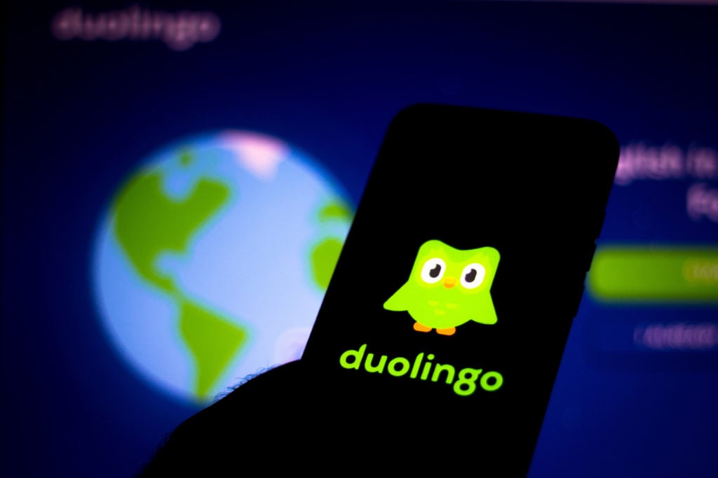 In this photo illustration the Duolingo logo seen displayed