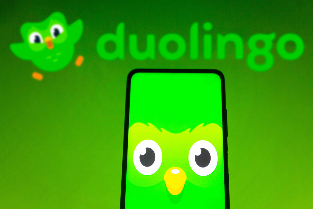 In this photo illustration the Duolingo logo seen displayed