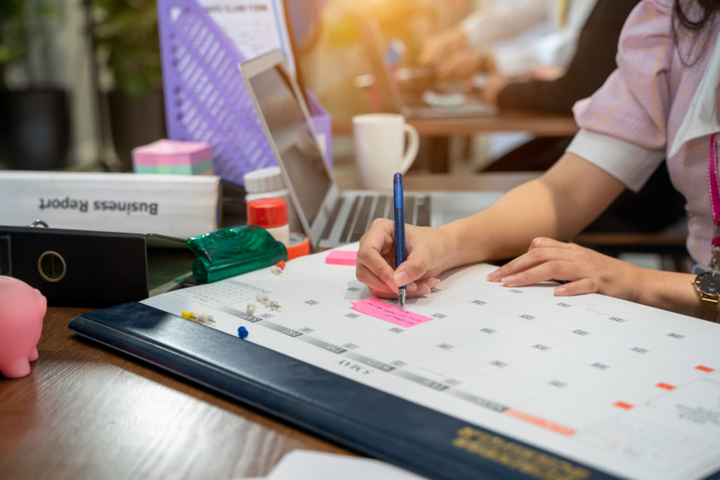 Business woman take notes in the calendar for make report or mea