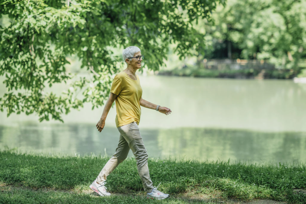 Mature woman walking by a lake