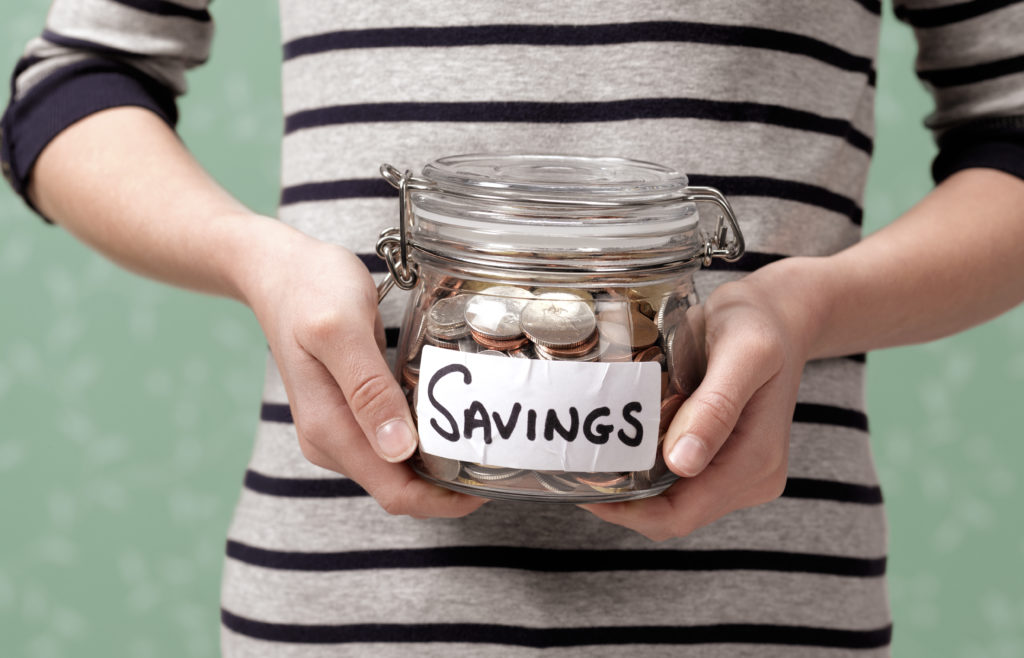 10 year old holding savings in jar