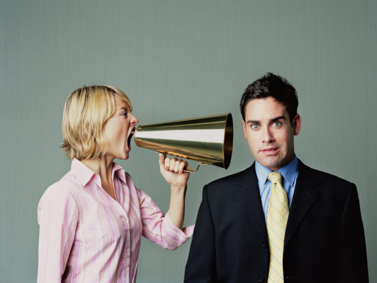 Woman shouting at men with phone
