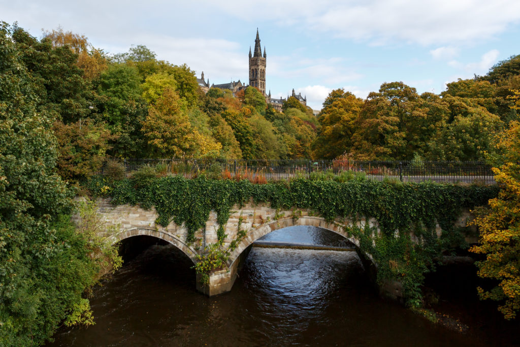 University of Glasgow behind lush trees, Glasgow, Scotland, UK