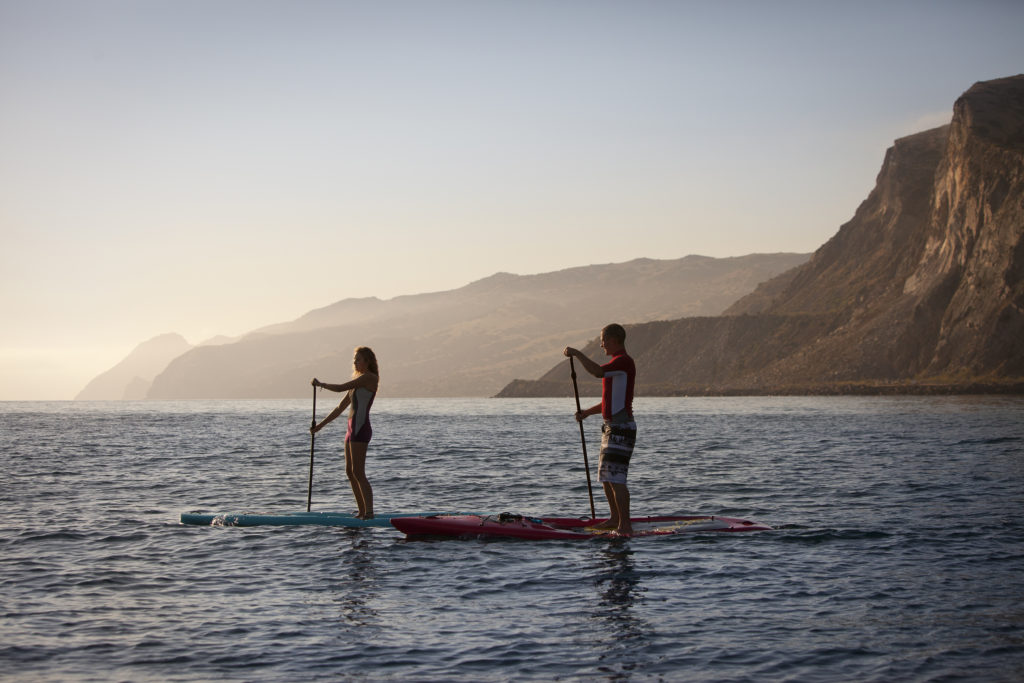 Two stand up paddle boarders on misty morning