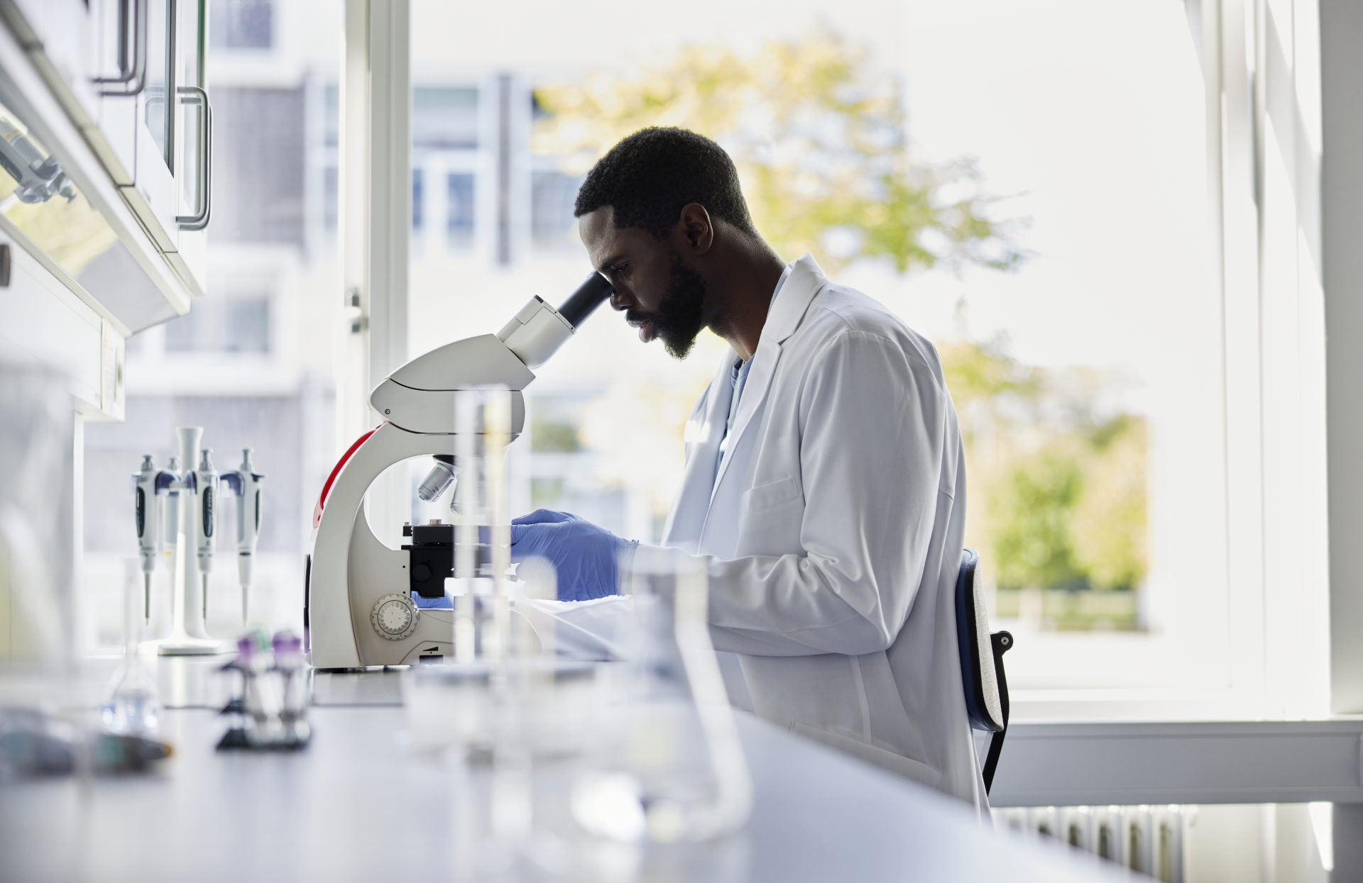 Scientist looking into microscope