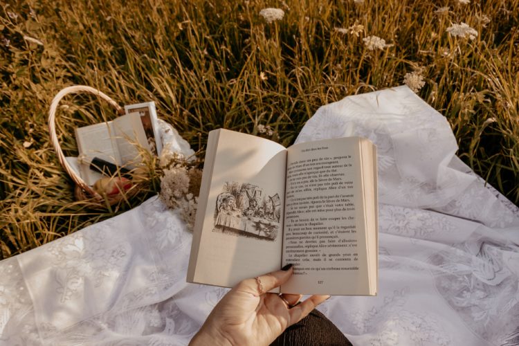 person holding white book page