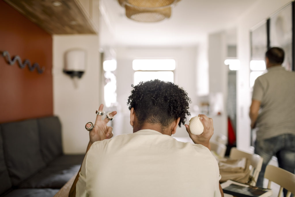 Rear view of female teenager sitting at home