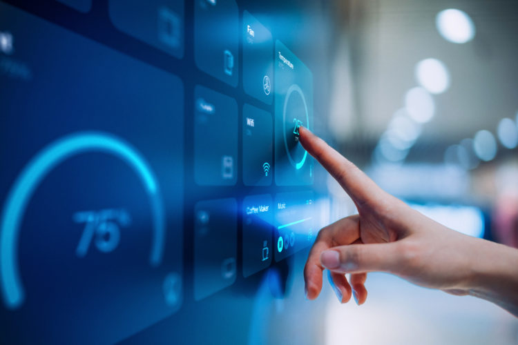 Close up of woman's hand setting up intelligent home system, controlling smart home appliances with control panel of a smart home. Home automated s...