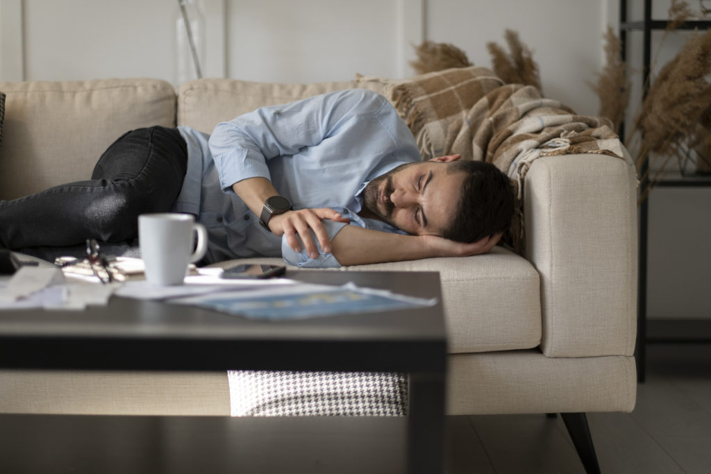 Man alone at home looking sad and distraught