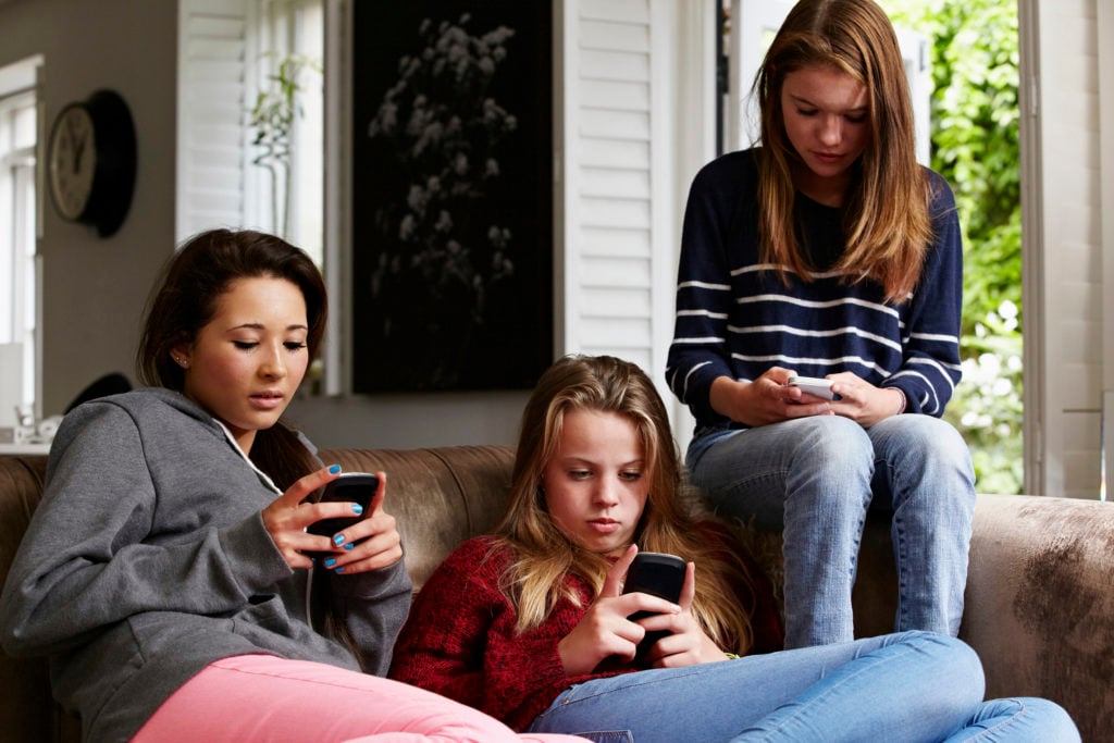 Teenage girls using cellphones