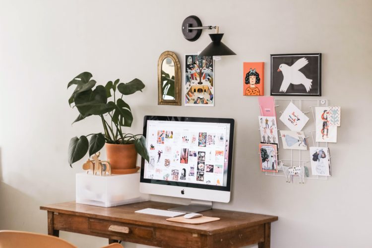 silver iMac on wooden desk