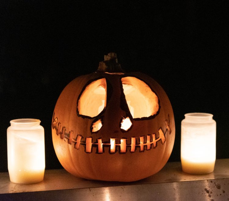 jack o lantern with white pillar candles