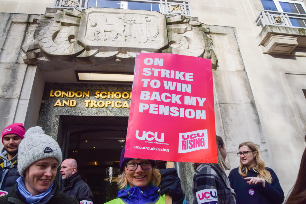 A University and College Union (UCU) member holds a placard