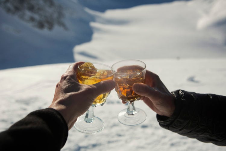 A toast of a hot toddy in the snow courtesy of Getty Images