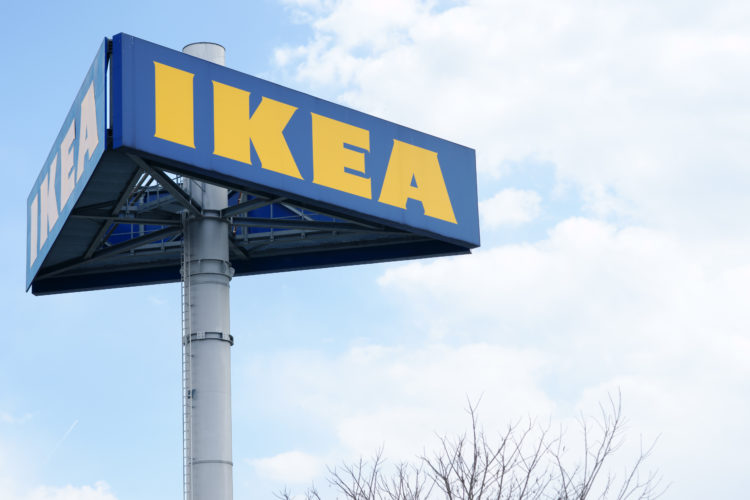 Graz, Austria - March 26, 2011: Large IKEA logo on pole in Graz. Clouded sky in background. Tree is partly visible in lower part of image. IKEA is ...