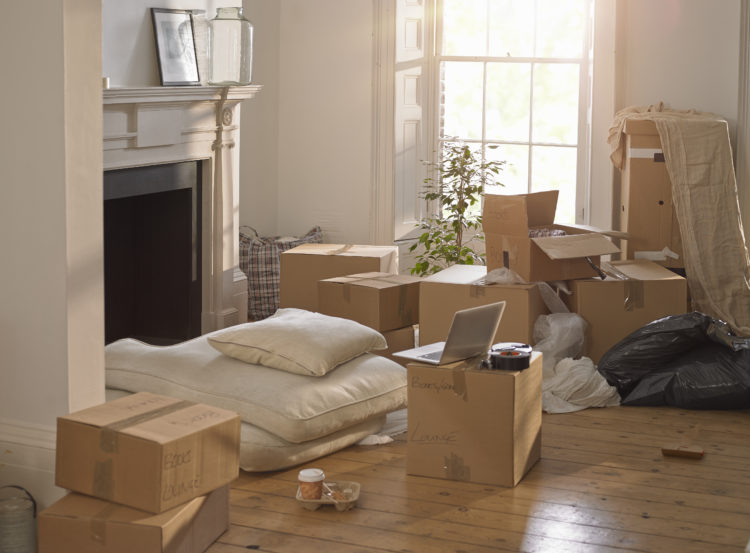 A room full of packing boxes and a laptop