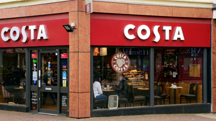 Waterlooville, UK - April 29, 2018: Costa coffee shop on the high street. Busy looking store front with advertising and seating. People inside are ...