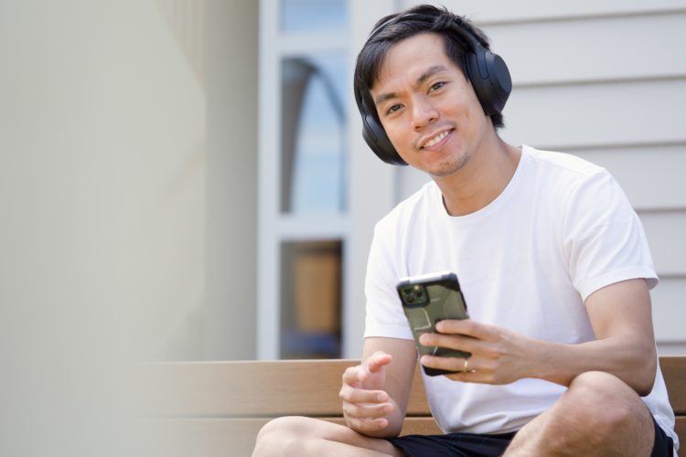 Happy man using his smartphone and headphones