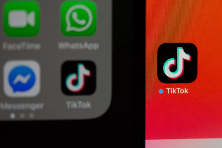 black and orange digital device showing TikTok app