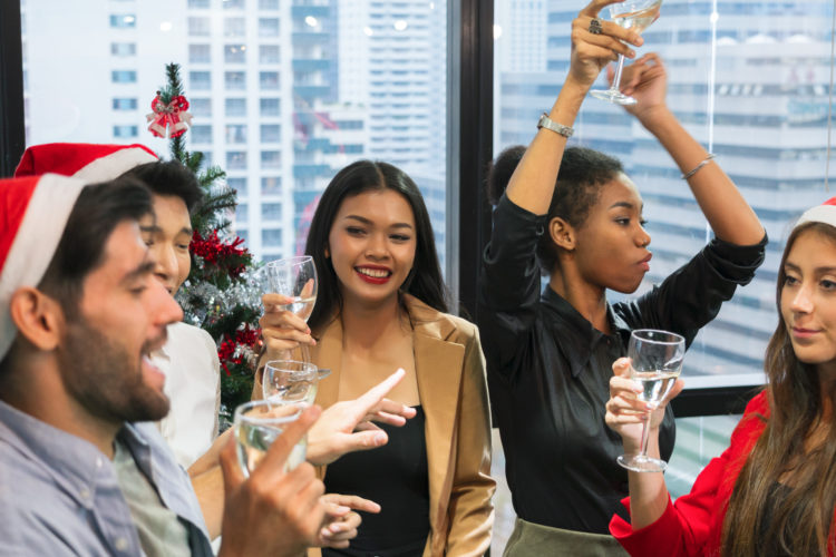 Businesspeople from many races celebrate Christmas, New Year's Day, in their hands, holding a glass of champagne for entertainment after work in th...