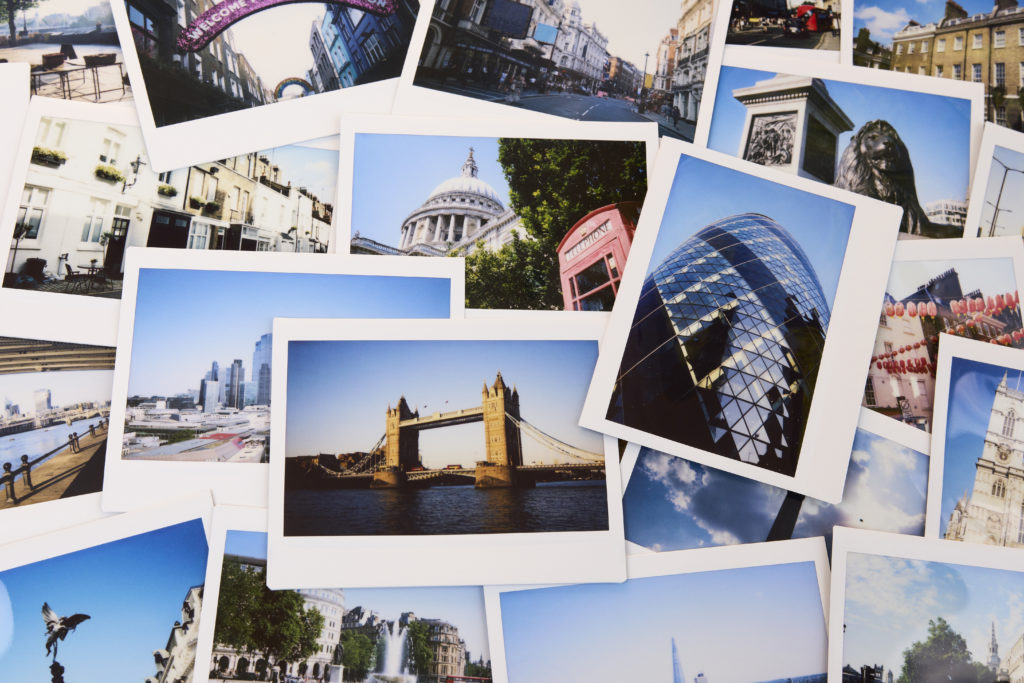 Collection of instant travel holiday photos of London on a table