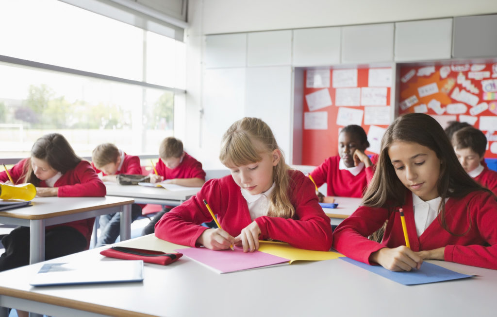 Students writing in classroom