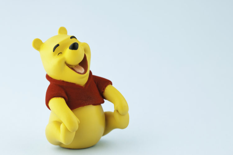 Suffolk, Virginia, USA - April 21, 2011: A horizontal studio shot of the Disney character Winnie the Pooh shot on a blue background. Winnie the Poo...
