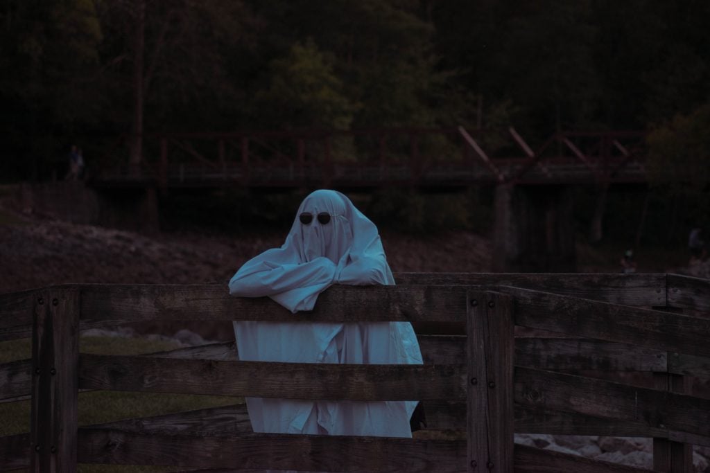 person dressed as ghost wearing sunglasses